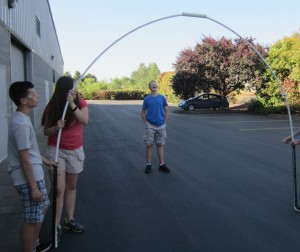students holding up pvc pipe